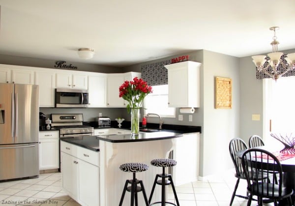 kitchen remodel with white cabinets with black and red accents