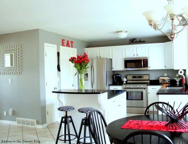 remodeled kitchen with island and barstools and inexpensive light fixtures