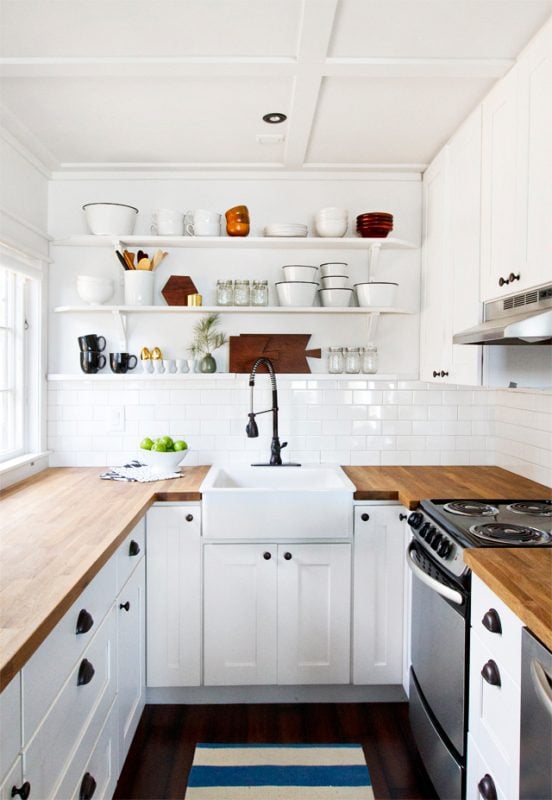 small horseshoe U-shaped kitchen layout with butcherblock countertops and open shelving via Smitten Studio