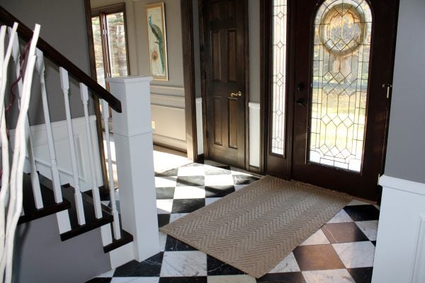 entry with checkered tile and curved staircase remodel - Construction2Style via @Remodelaholic