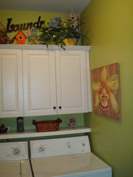 small green laundry room with floating shelf and cabinets, Southern Hospitality